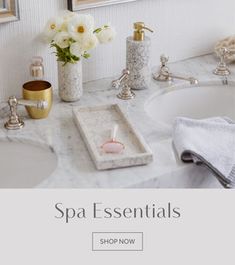 a white bathroom sink sitting under a mirror next to a counter top with soap and toothbrushes on it