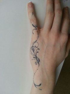 a person's hand with a tattoo on it and a flower design on the wrist