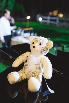 a teddy bear sitting on top of a piano