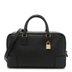 This is an authentic LOEWE Calfskin Amazona 28 Top Handle Bag in Black. This chic rectangular handbag is finely crafted of soft, supple calfskin leather. The bag features a wrap-around zipper, corner trim, and silverhardware. The top zipper opens to a roomy, black leather interior with zipper and patch pockets. Loewe Amazona Bag, Elephant Basket, Loewe Amazona, Corner Trim, Puzzle Bag, Small Elephant, Basket Tote, Handle Bag, Khaki Green