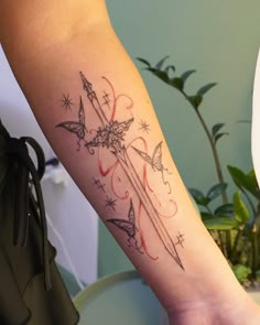 a person with a tattoo on their arm holding a knife and stars in the background