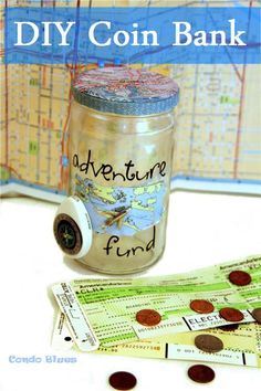 a jar filled with coins sitting on top of a table next to a map and coin bank