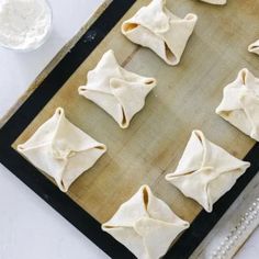 some dumplings are sitting on a baking sheet and ready to go into the oven