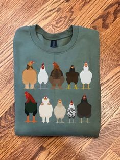 This Chicken Sweatshirt is great for Easter shirts or Women Chicken Shirt! This shirt makes a Funny Easter Shirt or Chicken Mom T-shirt! Our Farm Animal Tee Shirts are great for the Chicken lover or Chicken owner! Use as a Easter Tee or Chicken Tee for the Chicken mama in your life! { S H I R T / D E T A I L S } T-Shirts are 100% ringspun cotton and are UNISEX fit. Sweatshirts (no hood) & Hoodies (with hoods) are 50/50 cotton/polyester Both styles are soft & comfy. They are UNISEX size, fitting Green Crew Neck Novelty Top, Green Novelty Cotton Top, Green Cotton Novelty Top, Chicken Sweatshirt, Farm Chickens, Chicken Mama, Funny Easter Shirt, Chicken Owner, Chicken Mom