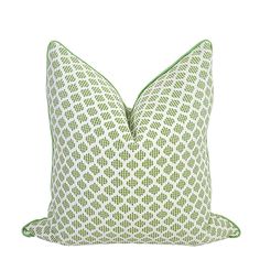 a green and white pillow on a white background