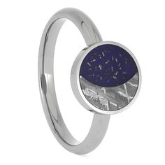 Proclaim your love for the “Moon of Your Life” or “Your Sun and Stars” with this starry night ring celebrating the bond between the stellar bodies of the night sky. The moon is displayed with Gibeon meteorite while dark blue Stardust™ creates a bright starry night sky. RING LAYOUTRing Width: 3 mm BandRing Sleeve: TitaniumRing Profile: RoundRing Finish: Polished 12 mm Round Setting with Gibeon Meteorite* and Blue Stardust Blue Celestial Moonstone Ring As Gift, Celestial Blue Moonstone Ring, Luxury Blue Celestial Rings, Night Sky Ring, Celestial Blue Cabochon Ring, Gibeon Meteorite, Meteorite Jewelry, Starry Night Sky, Sun And Stars