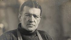 an old black and white photo of a man with suspenders looking at the camera