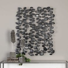 a metal wall sculpture with rocks on it