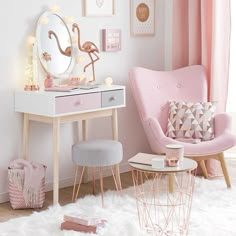 a room with pink furniture and pictures on the wall, including a vanity table and chair