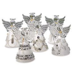 four silver and white angel figurines on a white background