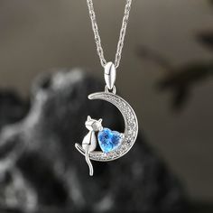 The pendant of this birthstone necklace features a gentle cat sitting quietly on the bright moon. A birthstone is set in the center, representing endless love and warmth. This moon necklace is full of tranquility and mystery, and you can choose to customize a unique color to add a soft light to your life. Whether it is given to yourself or to someone important to you, it will become a unique and precious gift.Carat Weight: 0.815 ctStone Size: 5*5 mmStone Type: Jeulia® StoneNumber of Stones: 1 St Fine Jewelry Moon-shaped Necklace For Anniversary, Elegant Blue Moon Shaped Necklace, Blue Jewelry With Cat Design For Gift, Elegant Blue Moon-shaped Necklace, Cat Design Pendant Jewelry, Endless Love, Christmas Wishlist, Moon Necklace, Birthstone Necklace