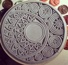 a plate that is sitting on a table with buttons in the backgroung