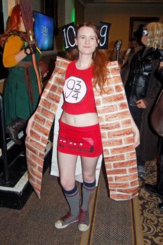 a woman dressed up as a brick character