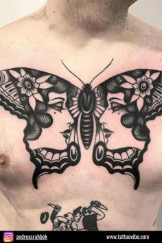 a man's chest with a black and white butterfly tattoo on his chest area