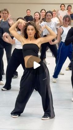 a group of people in a dance class doing different poses with their hands on their hipss