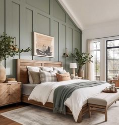 a bedroom with green walls and white bedding