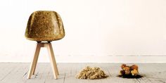 a wooden chair sitting on top of a white floor next to a pile of dirt