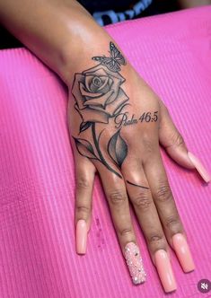 a woman's hand with a rose tattoo on it