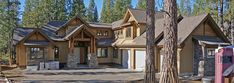 a large house in the woods with lots of trees around it and a parking meter