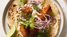 fish tacos with cole slaw and lime wedges