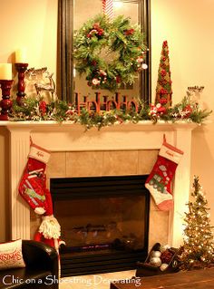 a living room decorated for christmas with stockings on the fireplace mantel and wreaths