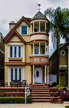 a large victorian style house with many windows and balconies