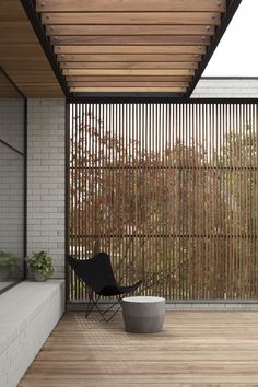 a black chair sitting on top of a wooden floor