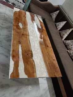 a wooden table sitting on top of a white marble floor