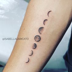 a person with a tattoo on their arm that shows phases of the moon