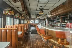 the inside of a restaurant with brown leather chairs