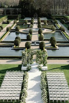 an outdoor ceremony setup with rows of white chairs