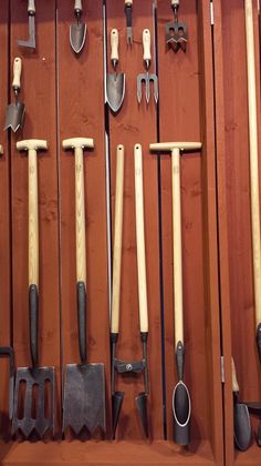 an assortment of tools are displayed on a wall