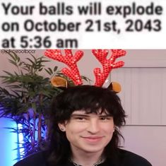 a man with long black hair wearing red reindeer antlers on his head and texting that reads, your balls will explode on october 21st, at 535 am