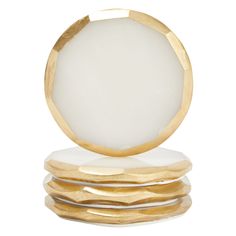 a white and gold ring sitting on top of each other