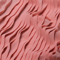 close up view of pink fabric with wavy lines on the top and bottom of it