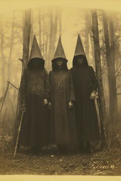 three witches standing in the middle of a forest