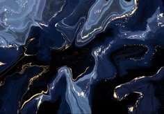 an abstract image of blue and gold paint on black paper with white clouds in the background