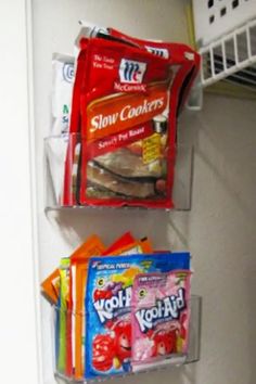 two clear shelves filled with snacks and candy bar wrappers on top of each other