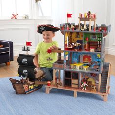 a young boy plays with his pirate ship toy