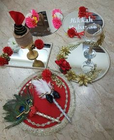 there are four mirrors on the floor with flowers and feathers in them, one has a feathered headband