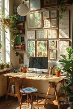 a desk with a computer on top of it next to a window filled with plants