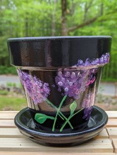 a flower pot sitting on top of a wooden table