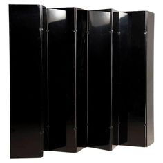 a room divider that is black and has four sections on each side, with one section