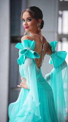 a woman in a blue dress posing for the camera