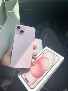 a person holding an iphone in their hand with the back cover removed from its box