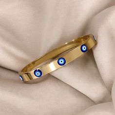 🧿Gold Evil Eye Bracelet, Blue Dainty Evil Eye Bracelet, Nazra Jewelry, Protection Gift, Hamsa Nazar Eye🧿 What Is Included: 1x Evil Eye Bracelet Gold plated bracelet featuring intricate evil eye design, the perfect gift for a friend or loved one.  🧿High Quality Gold And Steel Material  🧿Evil Eye Oversized Design 🧿30 Day Money Back Guarantee  At EyeSpyEvilEye, our family has dedicated over 4 years to designing and crafting quality products. Your support means the world to us as we continue to Evil Eye Gold Bracelet, Evil Eye Bracelet Gold, Gold Evil Eye Bracelet, Evil Eye Design, Bracelet Blue, Wedding Jewelry Bracelets, Eye Bracelet, Gold Plated Bracelets, Eye Design