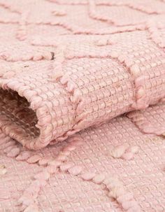 a close up view of a pink rug with fringes on the bottom and sides