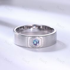 a silver ring with a blue diamond in the center