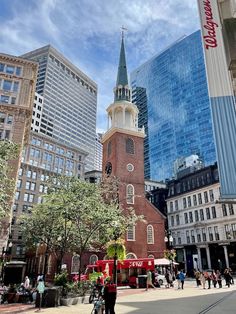 people are walking around in the city with tall buildings