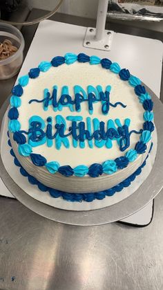 a birthday cake with blue frosting and the words happy birthday written on it is ready to be cut